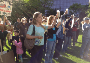 Food rights demonstrators for Alvin Schlangen raise bottles of raw milk in a toast photo