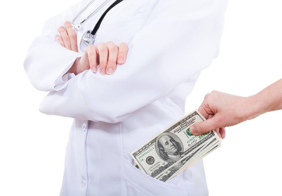 Patient bribing doctor putting money to pocket