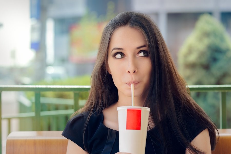 Portrait of a girl drinking trough a straw