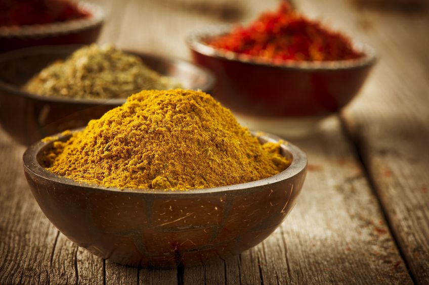 bowl of turmeric powder and other spices