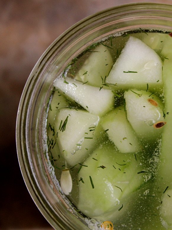 Image of Cucumber spears in the jar, ready to be weighted down and submerged beneath the brine.
