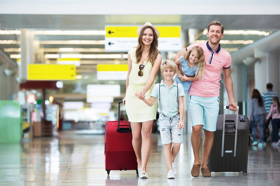 Happy family with suitcases in the airport