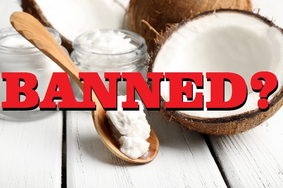 Coconut with jars of coconut oil and cosmetic cream on wooden background