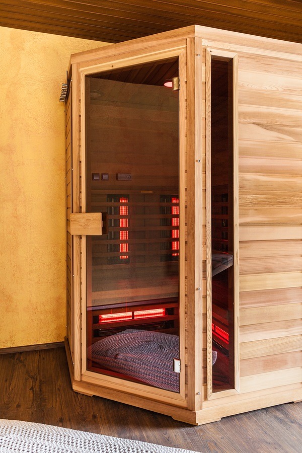 Picture of a small wooden infrared sauna booth in a spa