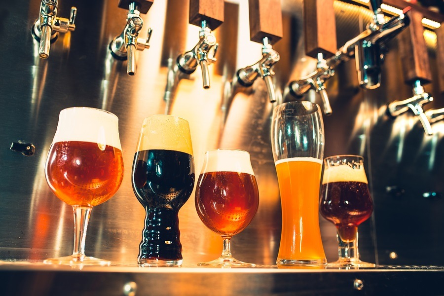 Beer taps in a pub. Vintage style. Beer craft. Glasses of beer image.