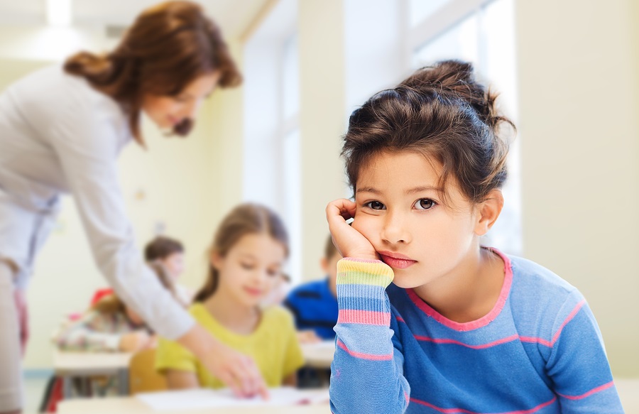 Young students in classroom with a teacher.