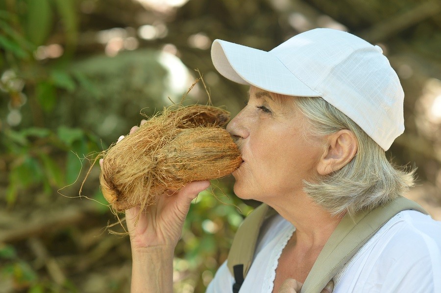 Older woman with a coconut photo