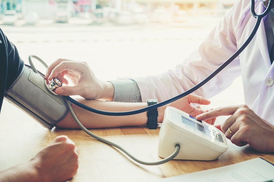 Doctor Measuring arterial blood pressure woman patient on right arm Health care in hospital