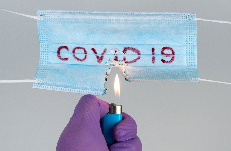 Protective Medical Mask With The Inscription Covid-19 Burns With