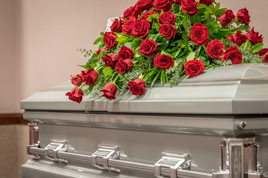Red Roses On Top Of Funeral Casket