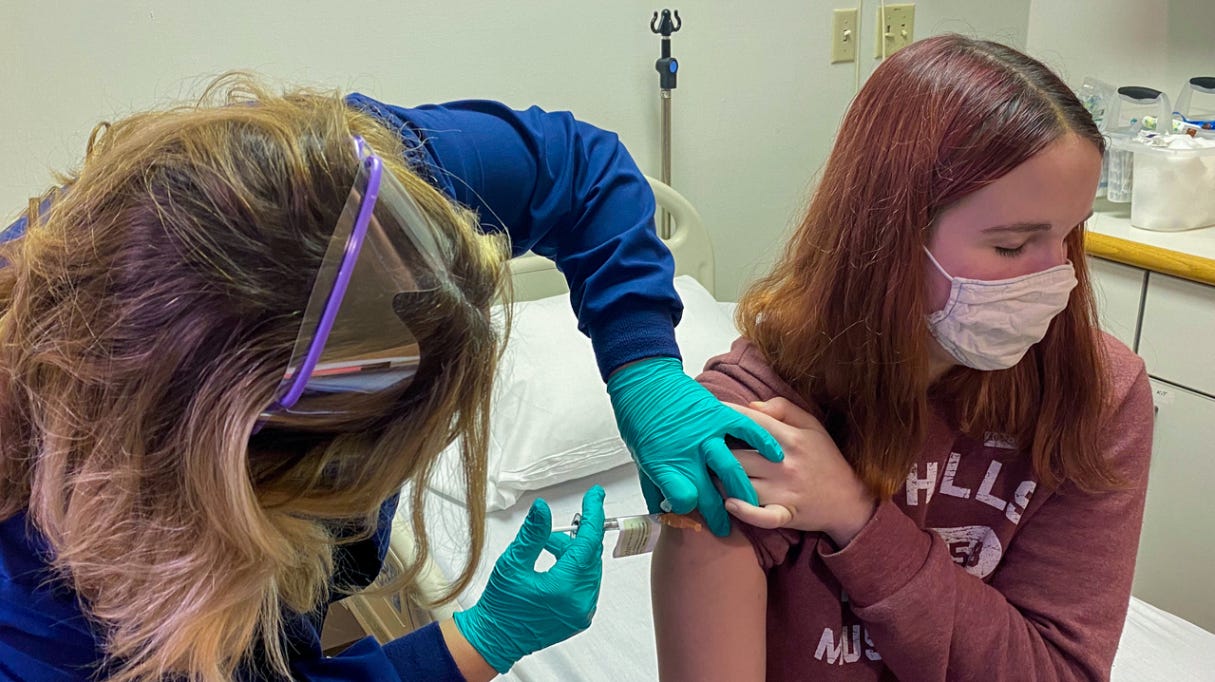 teen girl being vaccinated